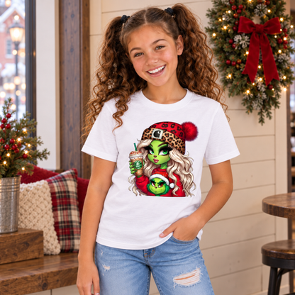 Youth white T-shirt with Boujee Green Girl Christmas graphic, modeled in a festive room with a wreath