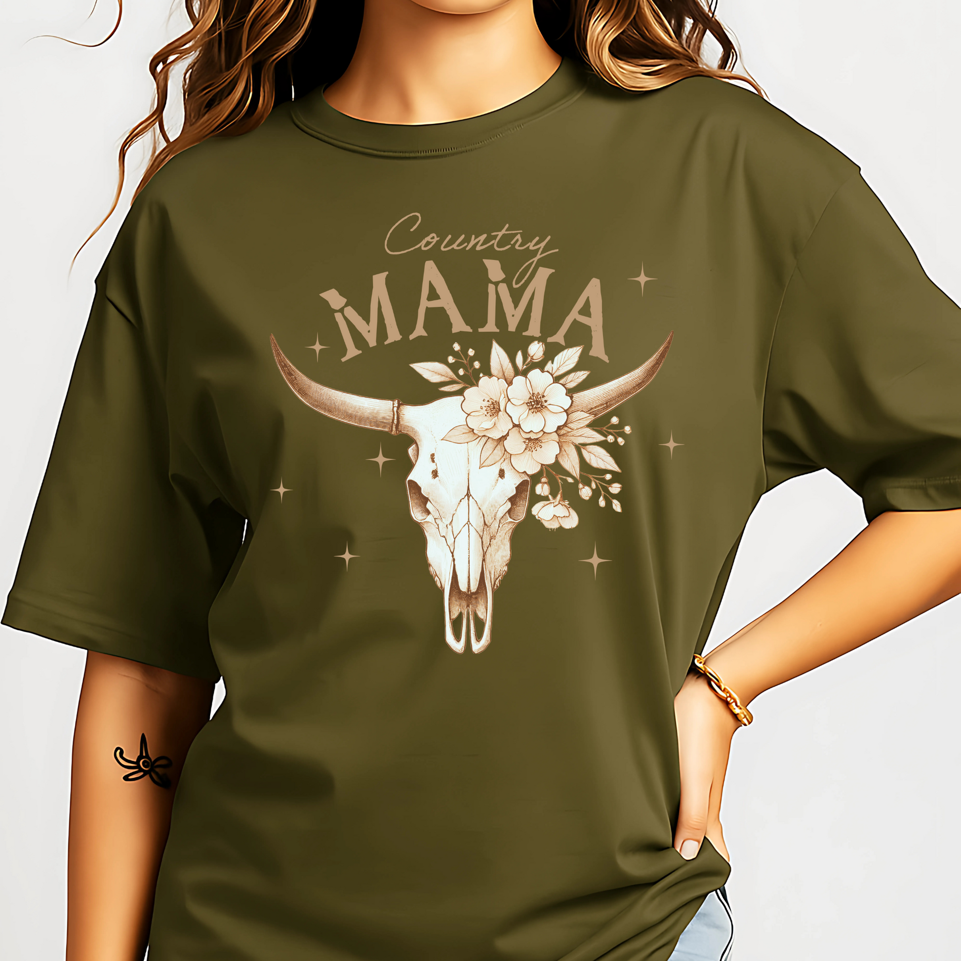 Woman wearing a Military Green,  Rustic "Country Mama" Tee. Featuring floral cow skiull. 