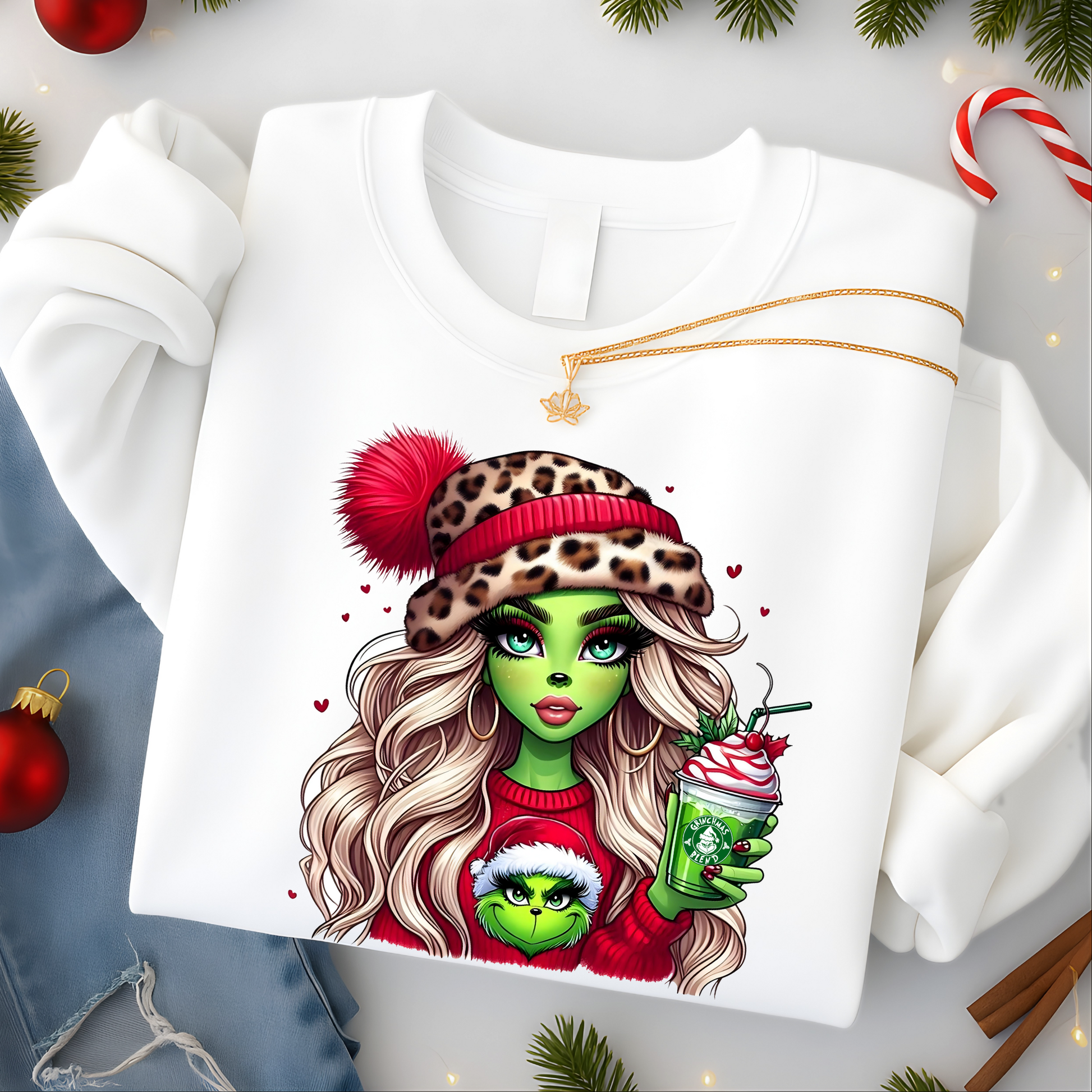 White sweatshirt with a festive design of a character holding a Starbucks cup, surrounded by Christmas decorations.