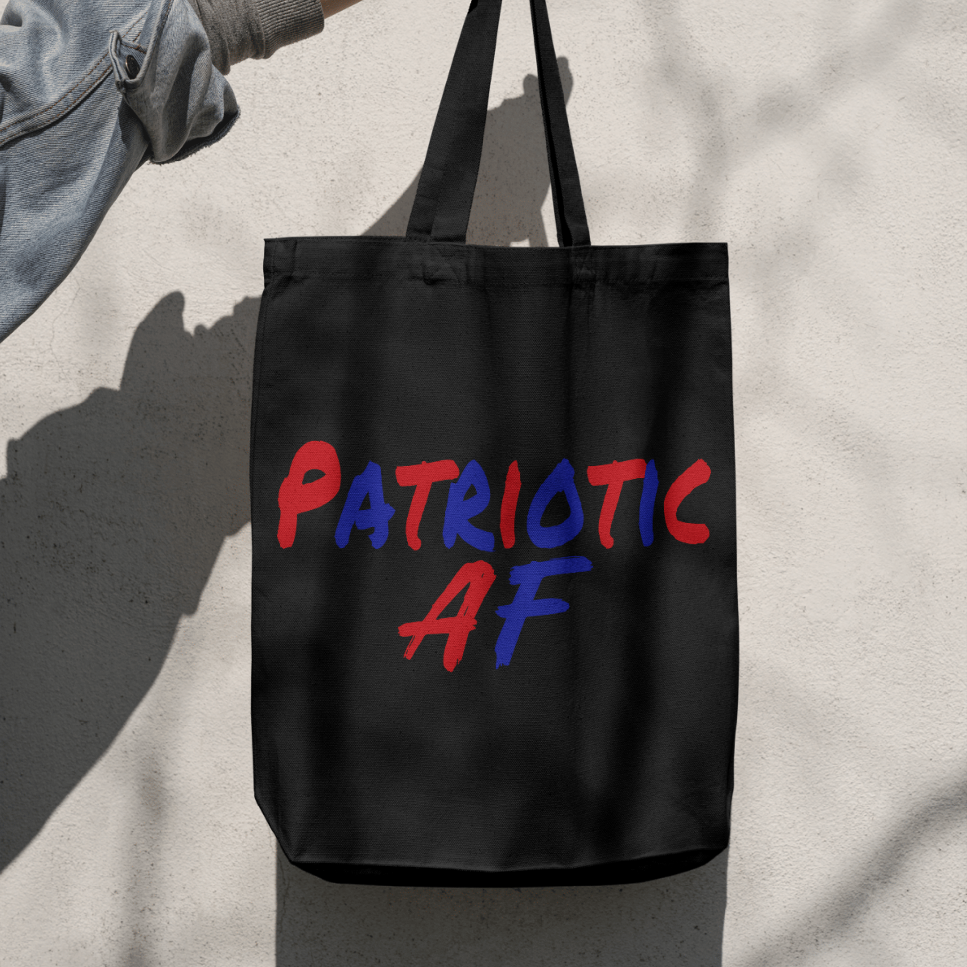 Black tote bag with Patriotic AF design in red and blue text