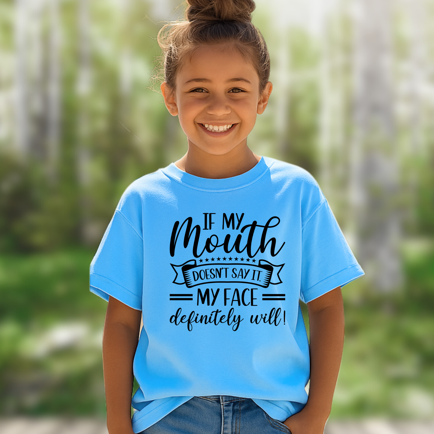 Happy girl outside in sky blue tee with bold lettering

