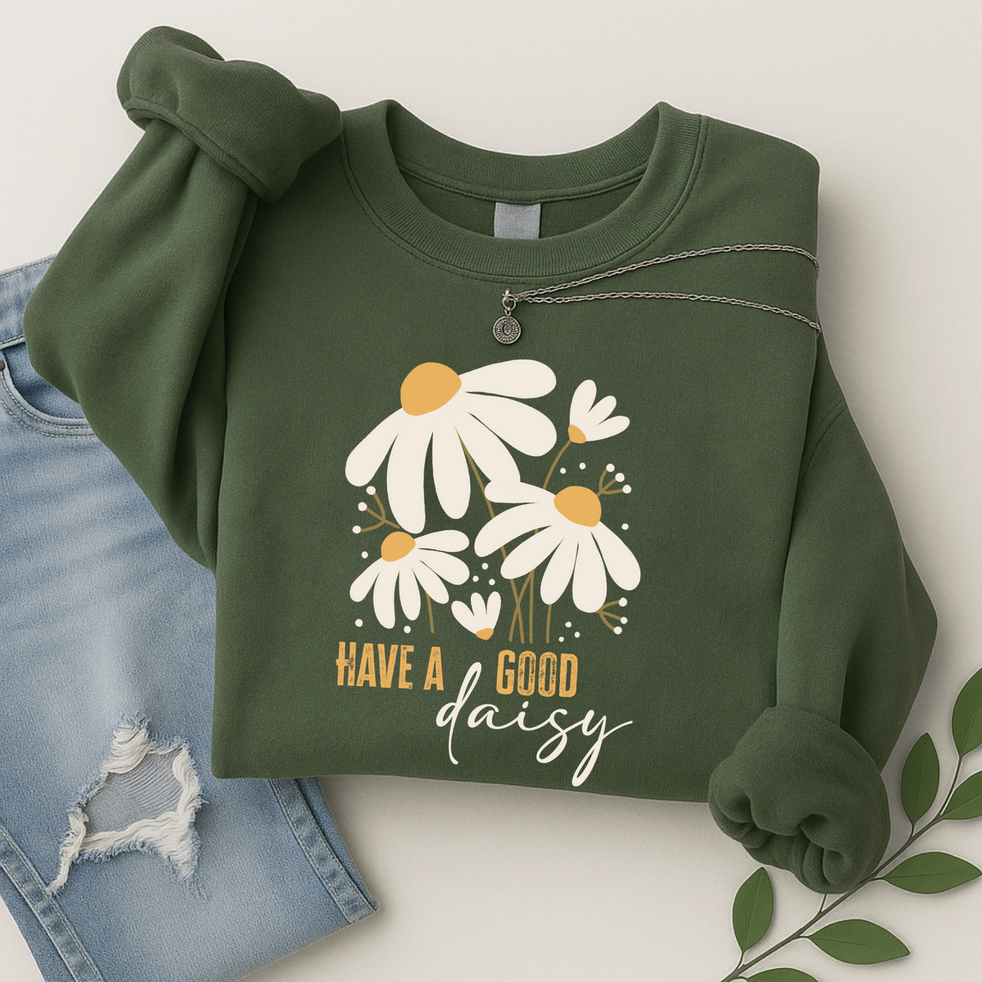 green daisy crewneck sweatshirt styled with light ripped jeans and necklace, great for Thanksgiving, fall outings, or comfy everyday wear in a warm autumn color palette.
