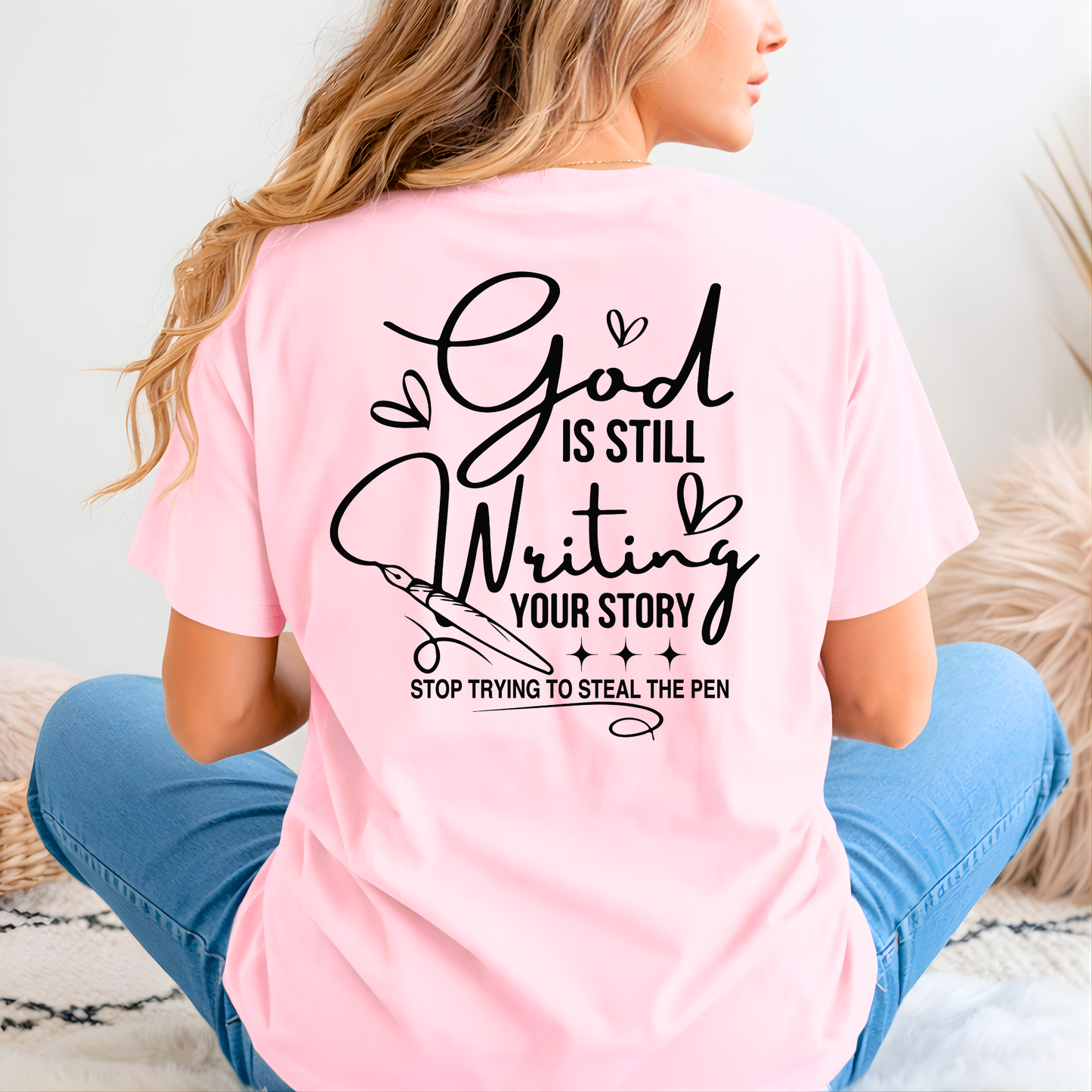 Person wearing a pink t-shirt with a motivational quote on the back.