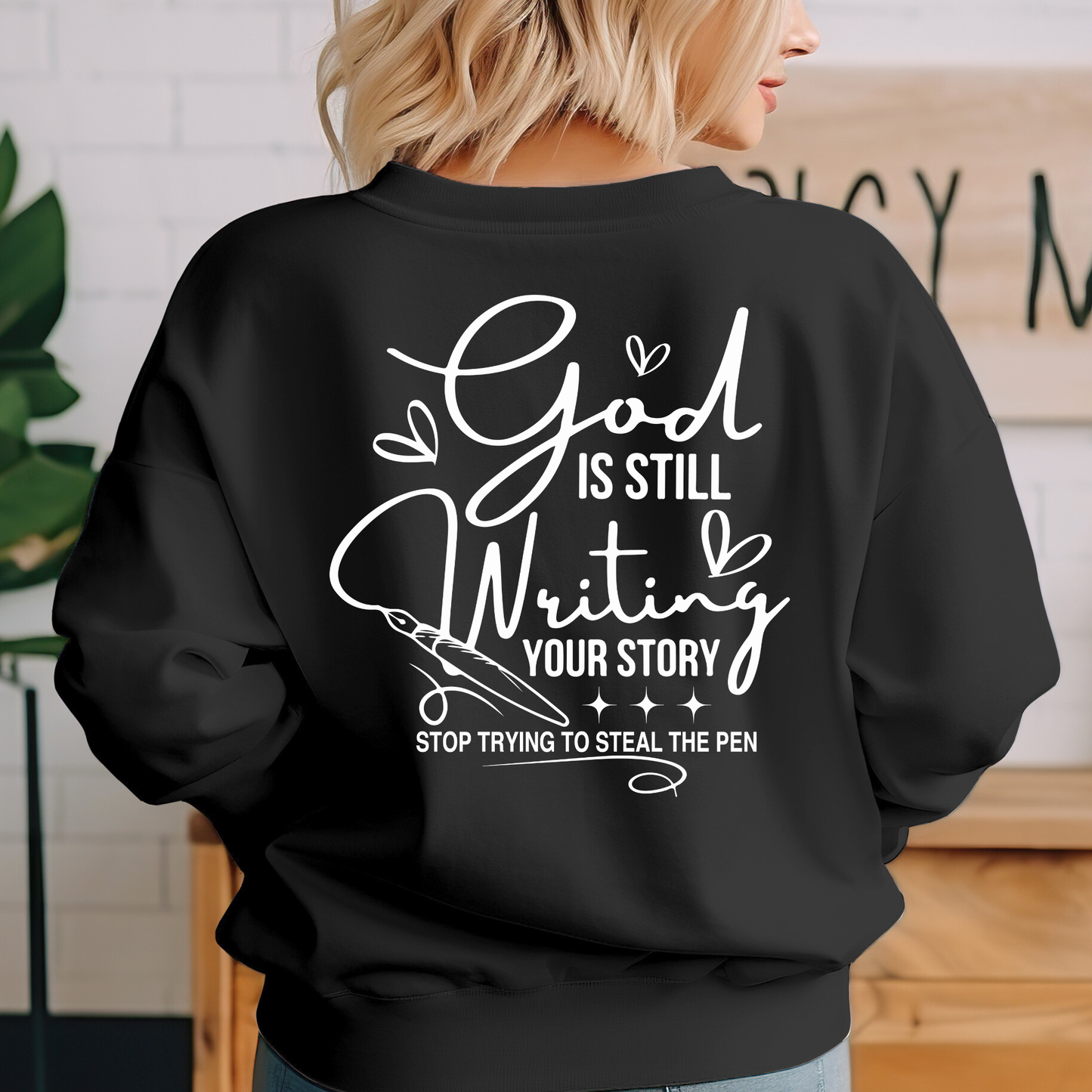 Black Christian sweatshirt back view with God Is Still Writing Your Story religious quote