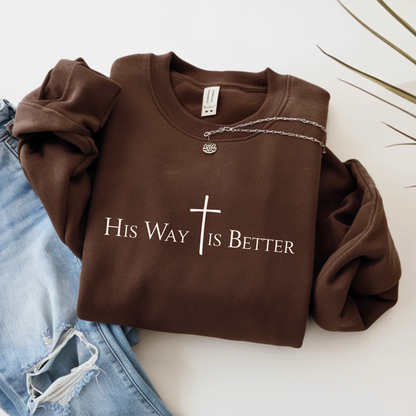 Brown sweatshirt with 'His Way is Better' text and cross on a white background