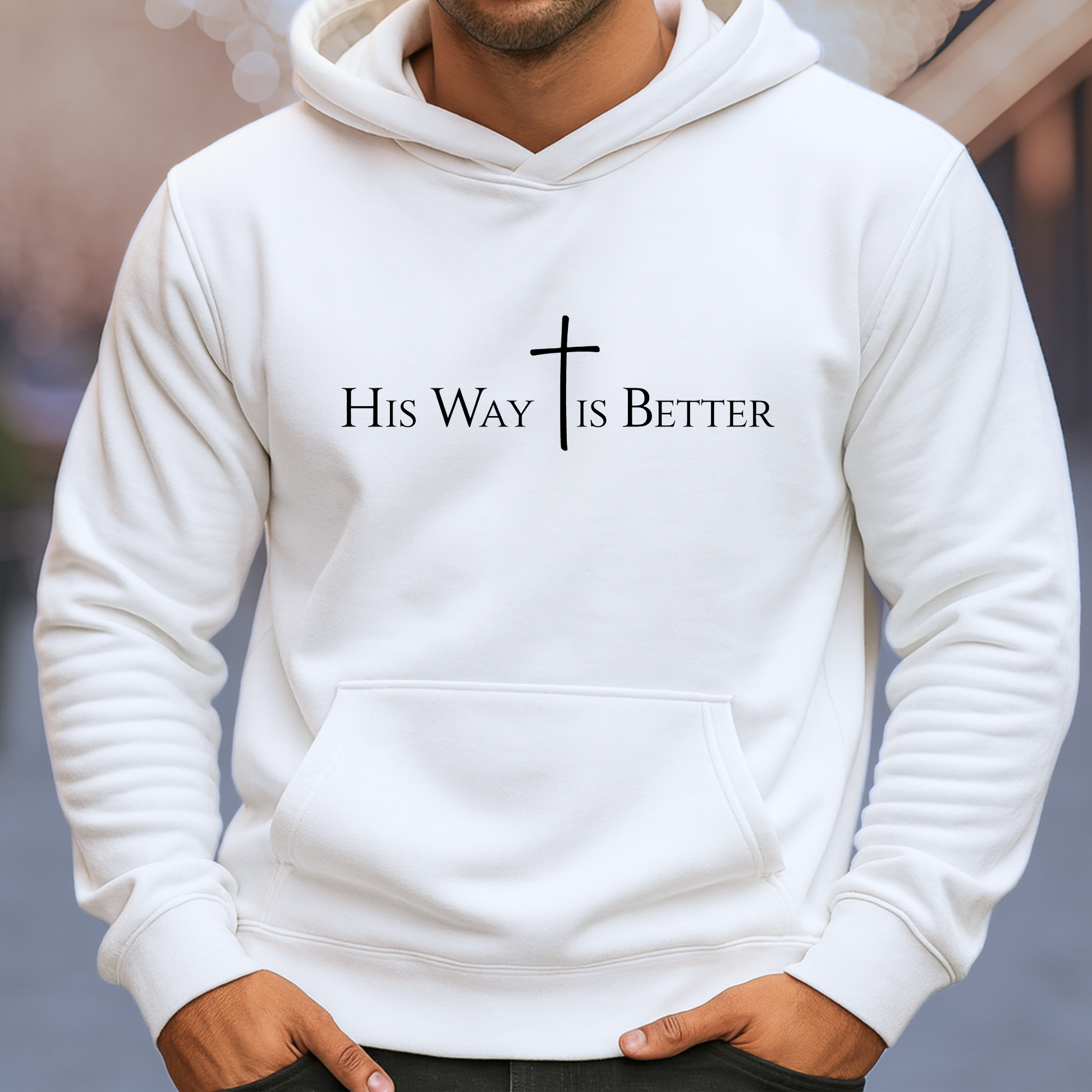 White hoodie with 'His Way is Better' text and cross design on a blurred background