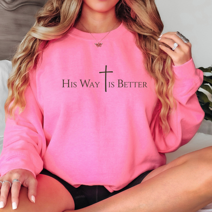 Woman wearing bright pink “His Way Is Better” Christian sweatshirt with cross design