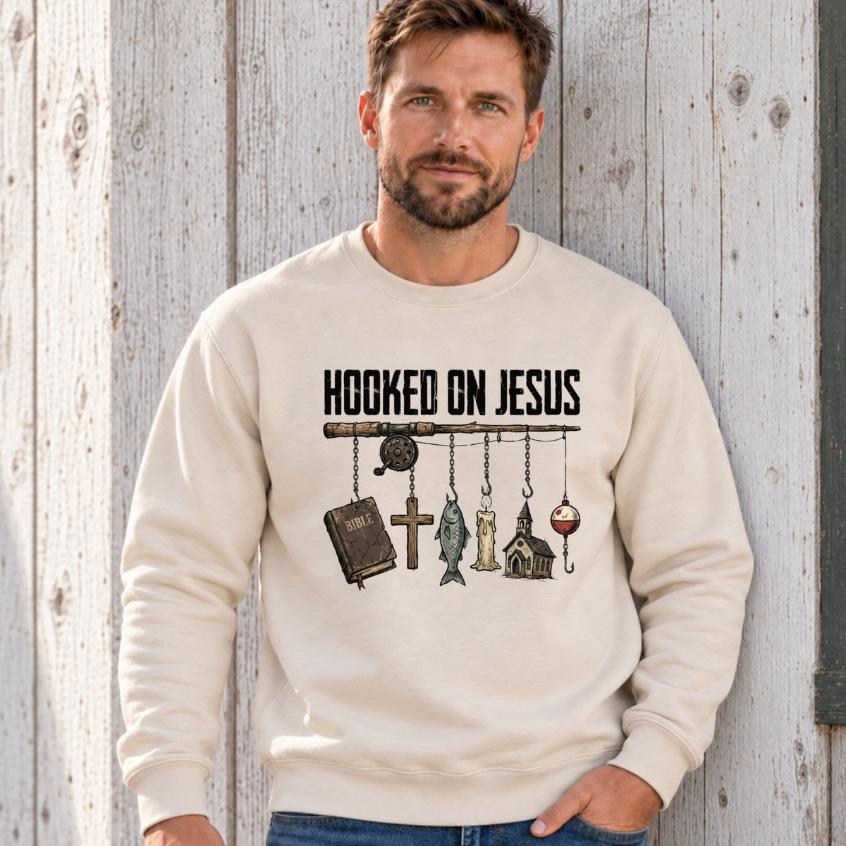 Man wearing a sand colored Hooked on Jesus Creswneck on a lakeside cabin deck.n