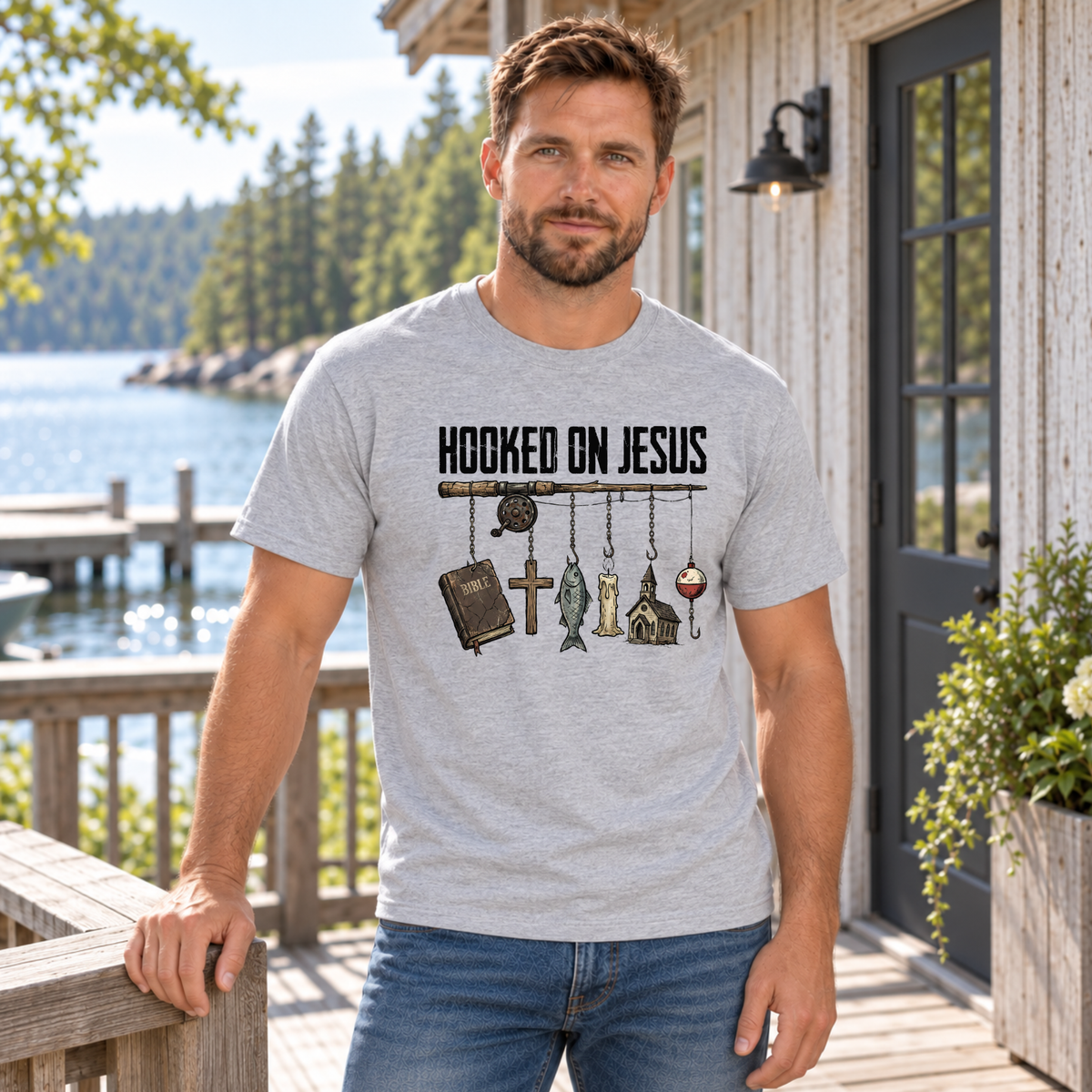 Man wearing a sports gray Hooked on Jesus T-shirt on a lakeside cabin deck.