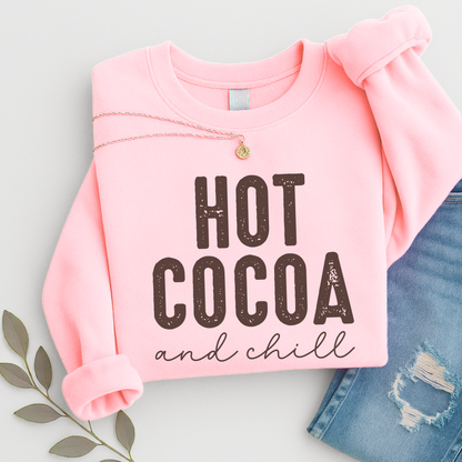 Hot Cocoa and Chill sweatshirt in pink – folded flat lay with necklace and jeans