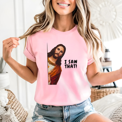Woman wearing a pink religious  t-shirt with a graphic Jesus and text, sitting in a casual setting.