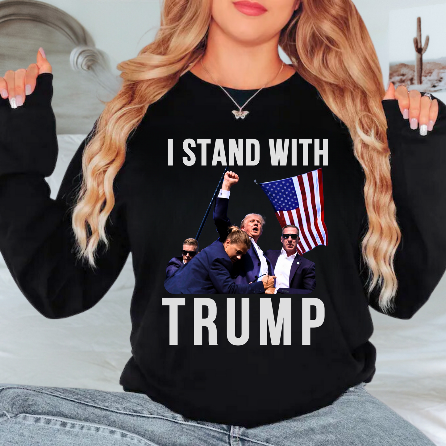 Woman wearing “I Stand With Trump” sweatshirt in Black with American flag – patriotic apparel
