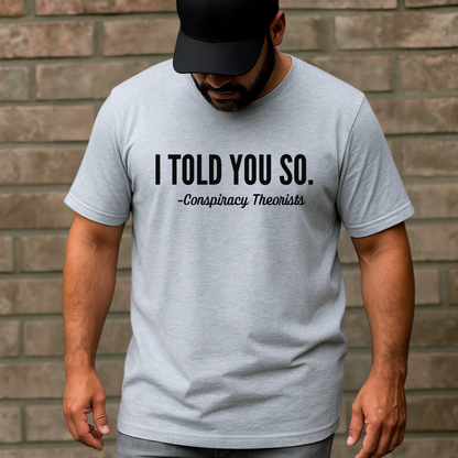 Man wearing gray short sleeve t-shirt with black “I Told You So – Conspiracy Theorists” text