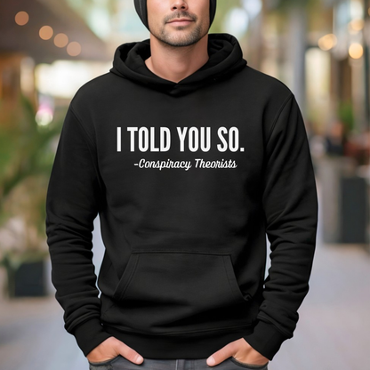 Man wearing black pullover hoodie with “I Told You So – Conspiracy Theorists” text design