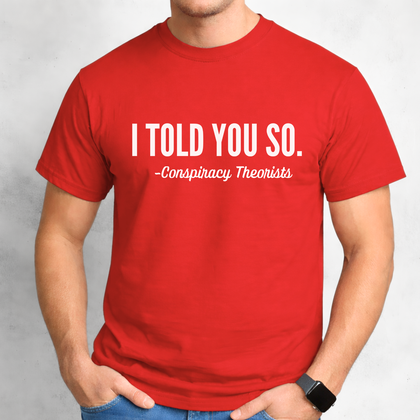 Man wearing red short sleeve t-shirt with white “I Told You So – Conspiracy Theorists” lettering