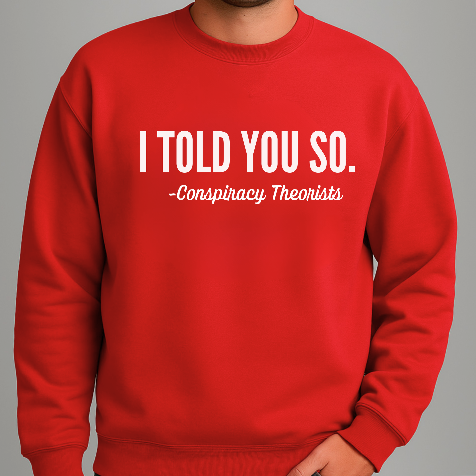 Man wearing red crewneck sweatshirt with “I Told You So – Conspiracy Theorists” text design