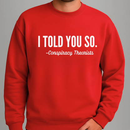 Man wearing red crewneck sweatshirt with “I Told You So – Conspiracy Theorists” text design