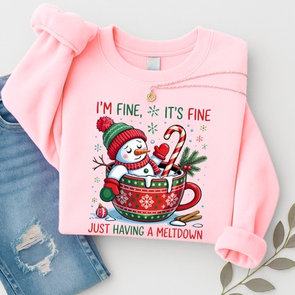 Flat lay of pink snowman sweatshirt folded with necklace and jeans