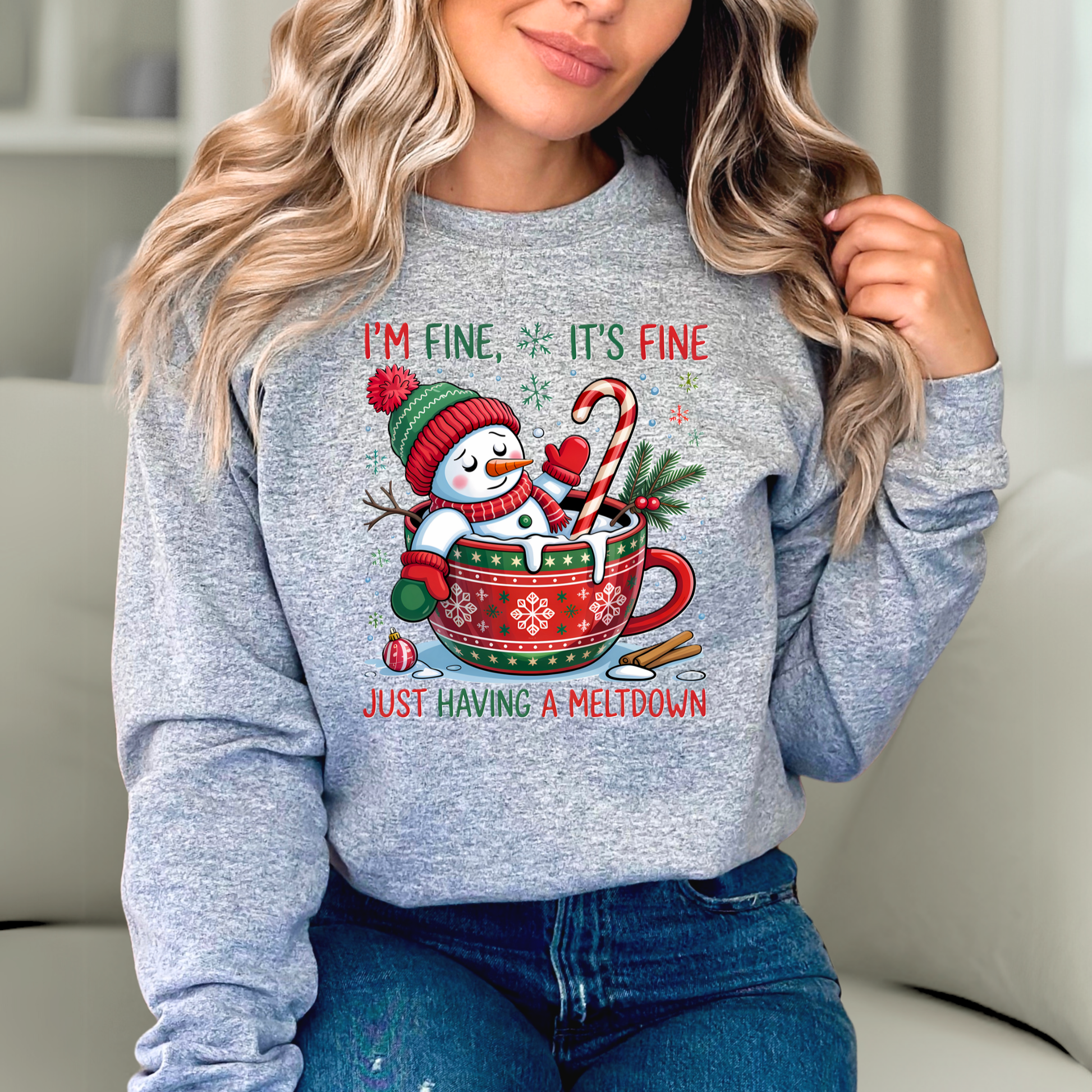Sports gray sweatshirt featuring melting snowman in red holiday mug with candy cane