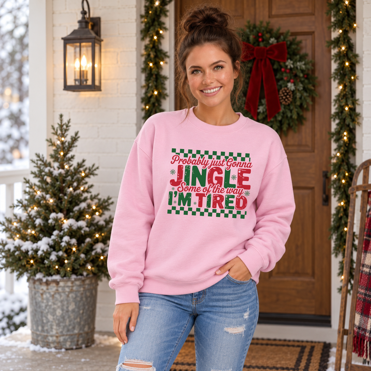 Woman wearing a light pink sweatshirt with red and green Probably Just Gonna Jingle Some of the Way I'm Tired Christmas design