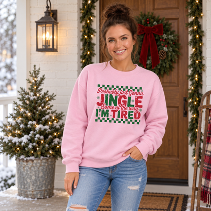Woman wearing a light pink sweatshirt with red and green Probably Just Gonna Jingle Some of the Way I'm Tired Christmas design
