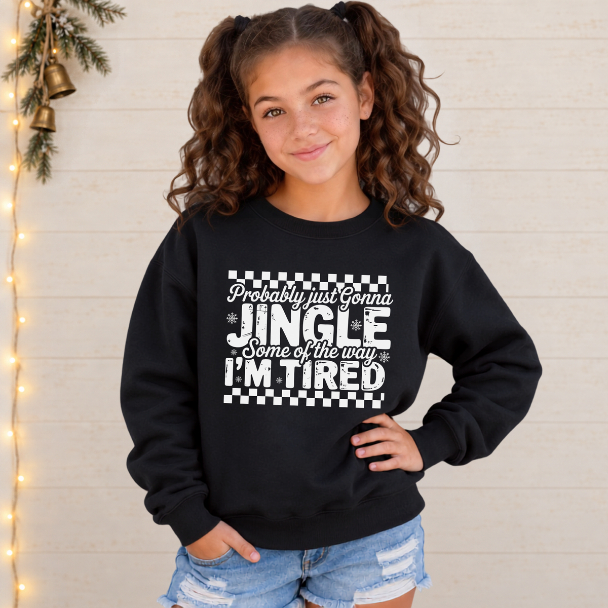 Girl wearing a black youth sweatshirt with white Probably Just Gonna Jingle Some of the Way I'm Tired Christmas design