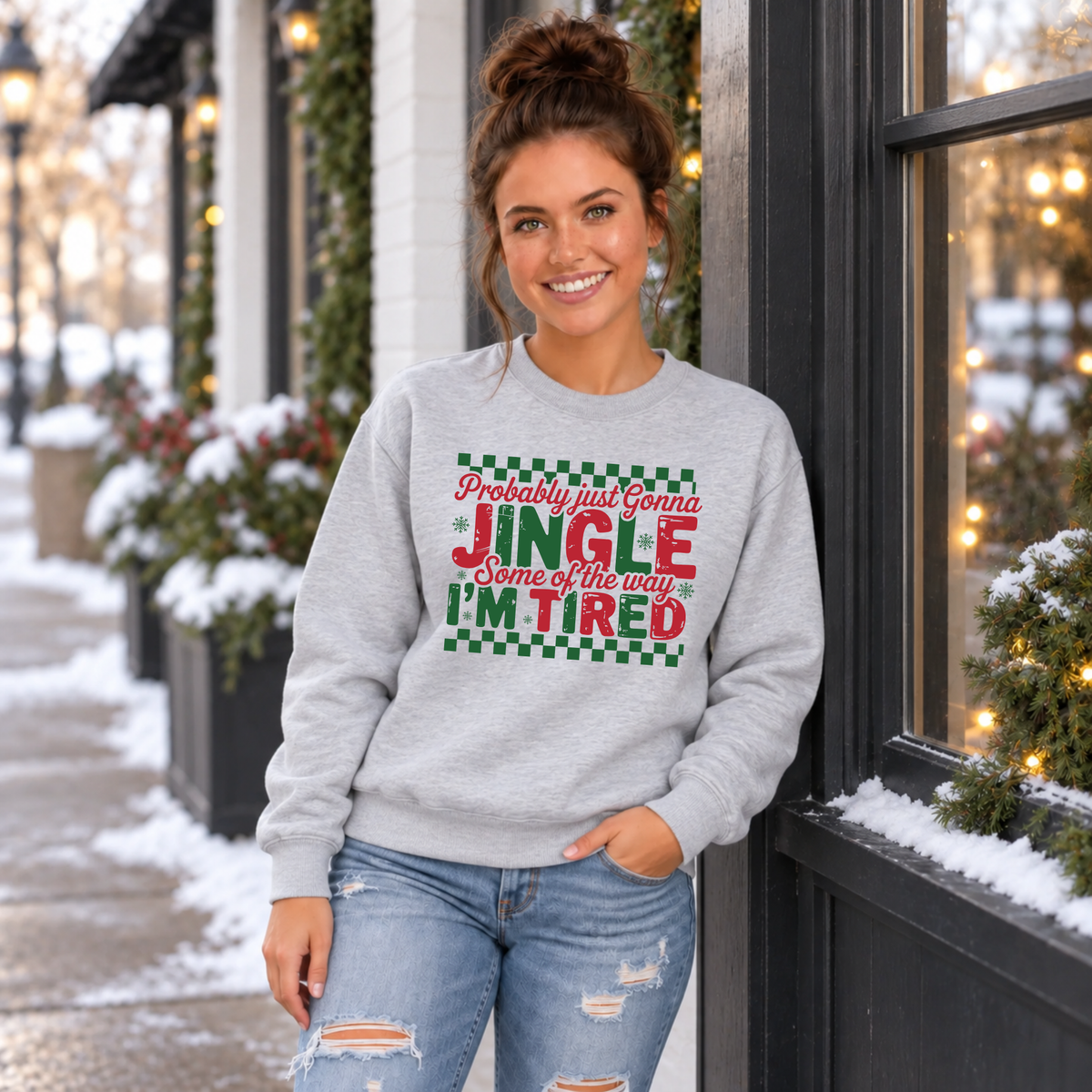 Woman wearing a sport gray sweatshirt with red and green Probably Just Gonna Jingle Some of the Way I'm Tired Christmas design outdoors
