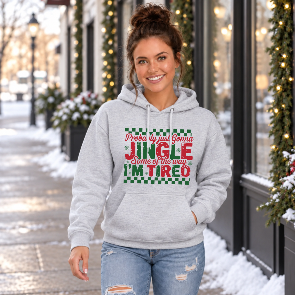 Woman wearing a sport gray hoodie with red and green Probably Just Gonna Jingle Some of the Way I'm Tired Christmas design outdoors
