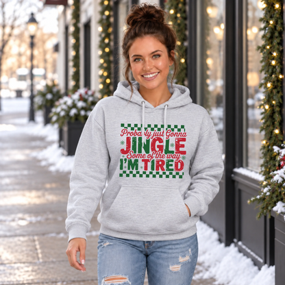 Woman wearing a sport gray hoodie with red and green Probably Just Gonna Jingle Some of the Way I'm Tired Christmas design outdoors