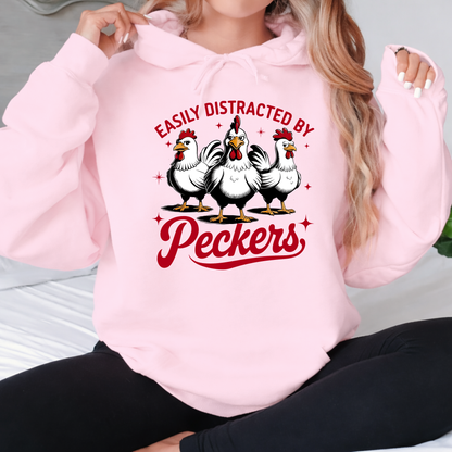 Lady wearing a pink hoodie with chicken graphic and text "Easily distracted by Peckers