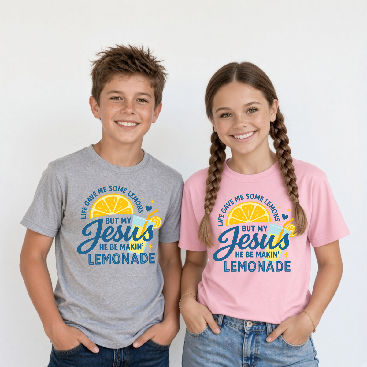 Youth boy in sports gray T-shirt and youth girl in light pink T-shirt wearing the Jesus Be Makin’ Lemonade graphic.