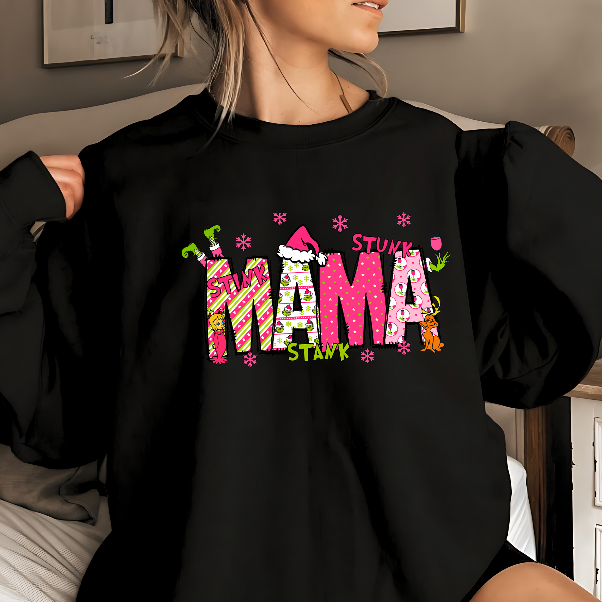 Black sweatshirt with "Mama" Christmas design, woman smiling
