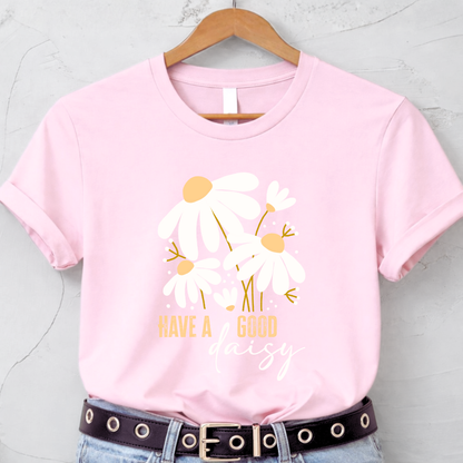 Pink t-shirt with floral design and text on a hanger against a light gray background