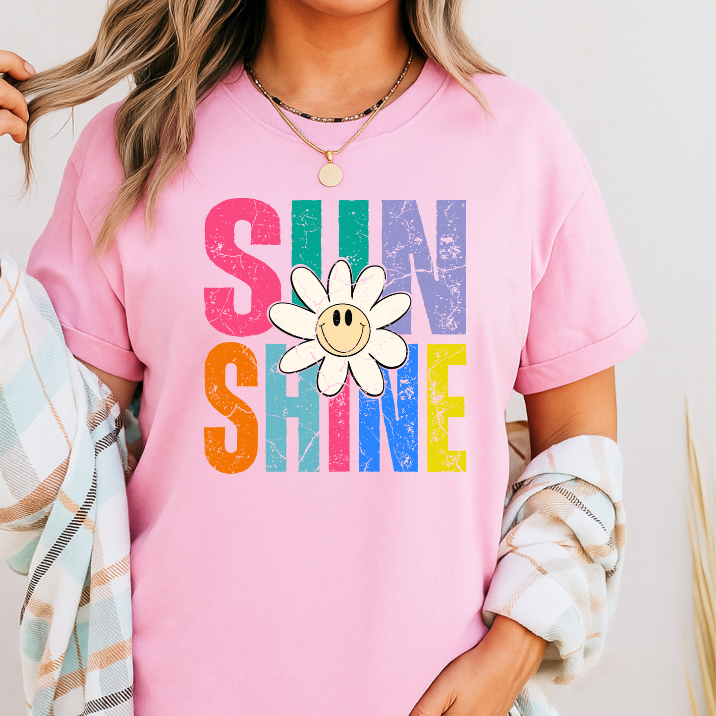 Light pink shirt styled in feminine boho room