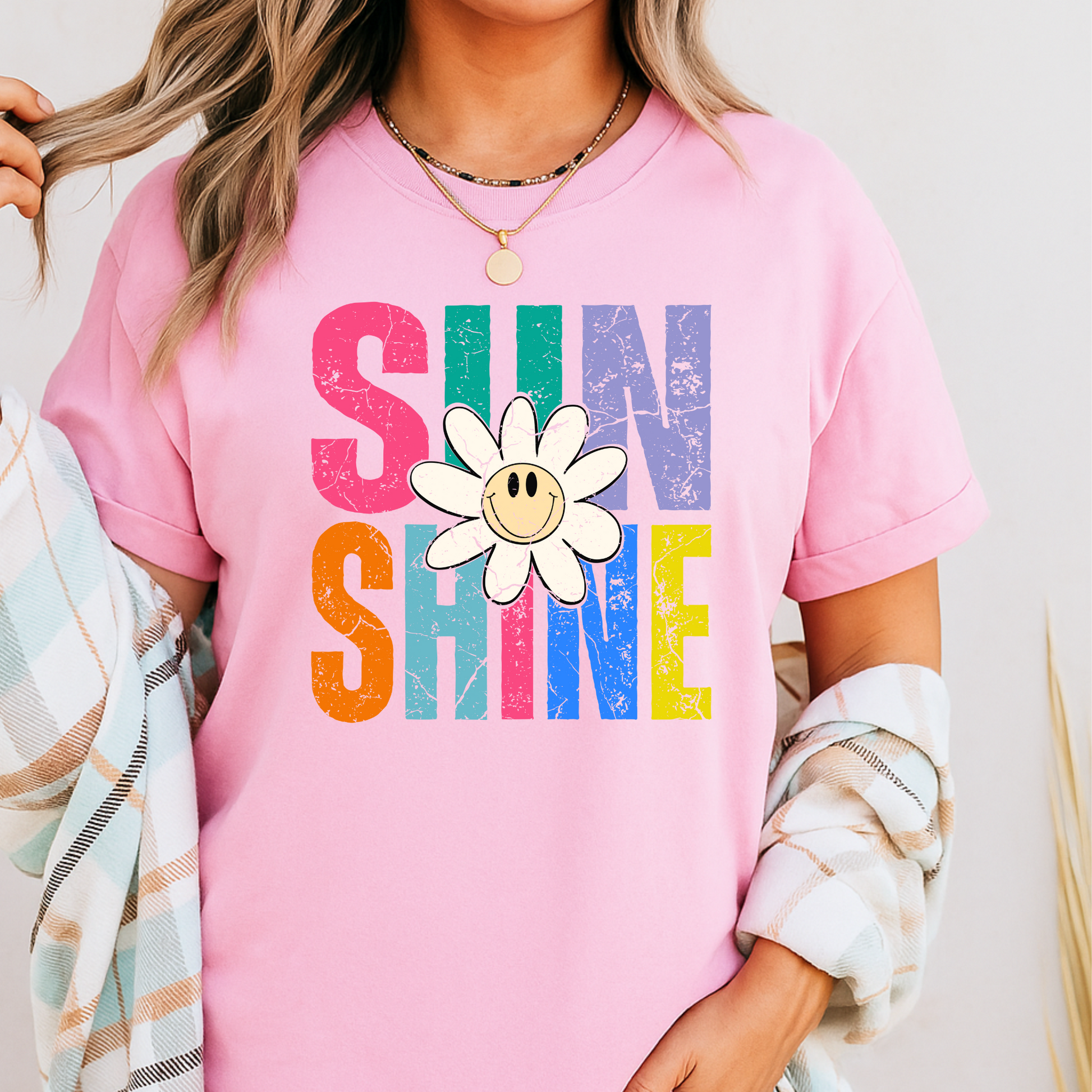 Light pink shirt styled in feminine boho room