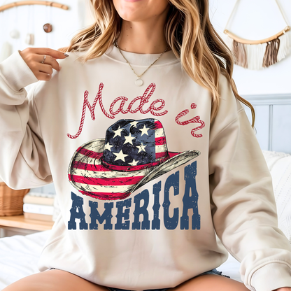 Woman wearing a beige sweatshirt with 'Made in America' graphic design.