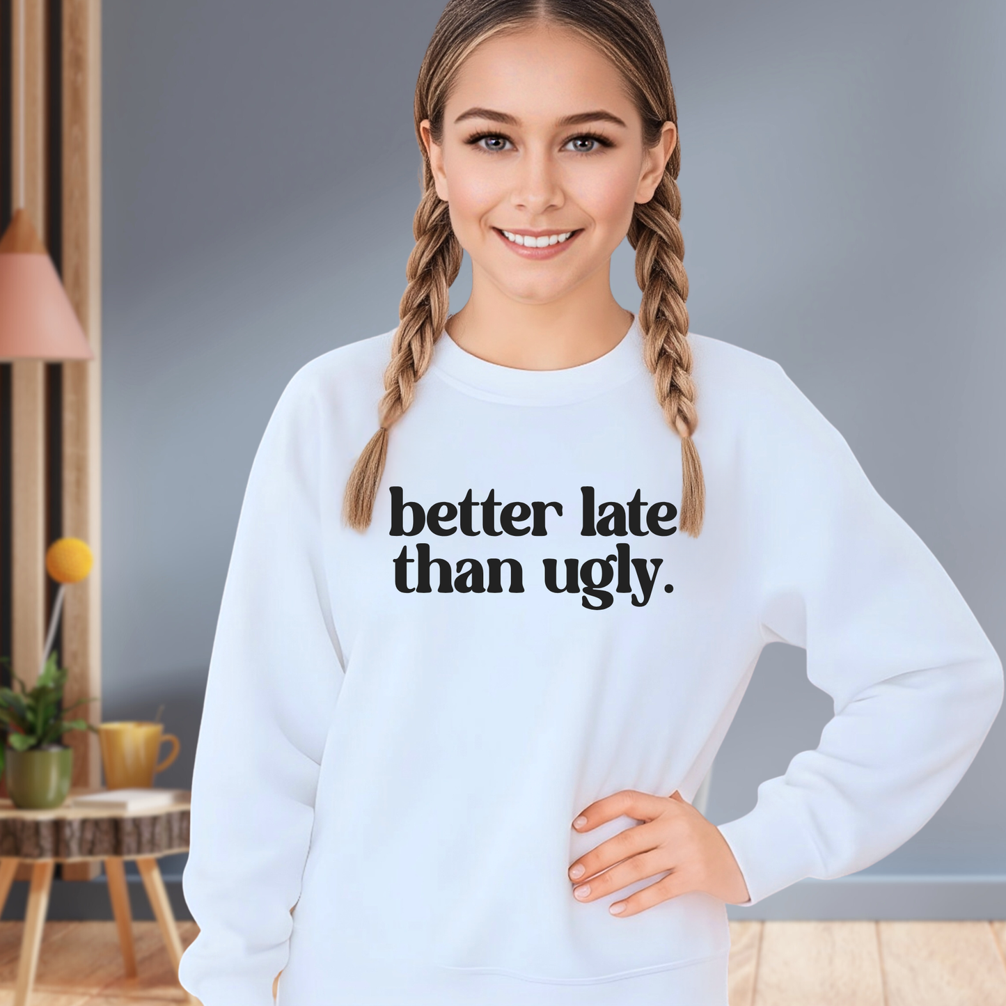 Girl wearing light blue Better Late Than Ugly youth sweatshirt hands on hips