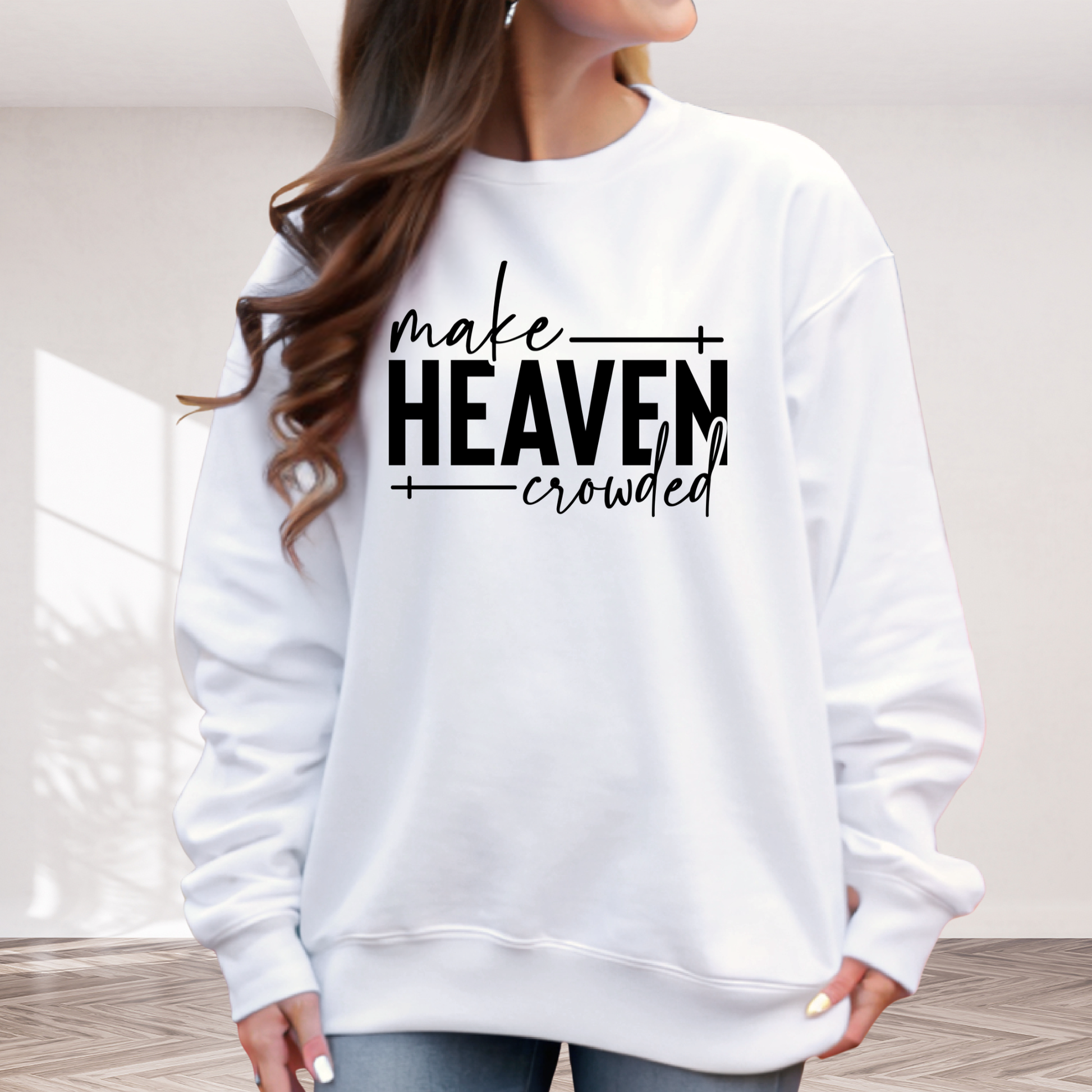 Make Heaven Crowded design on white sweatshirt worn by woman outdoors
