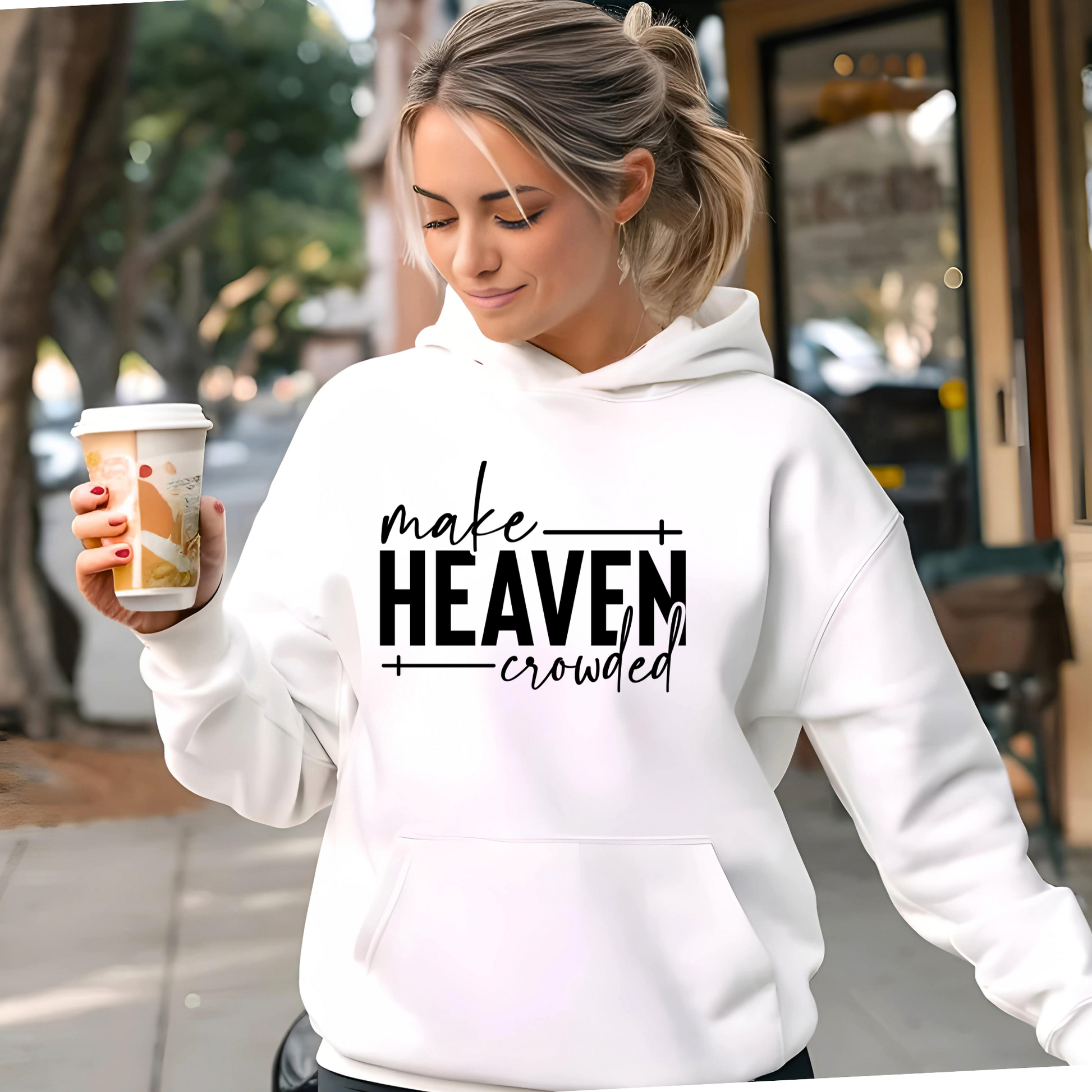 Make Heaven Crowded design on white sweatshirt worn by woman outdoors