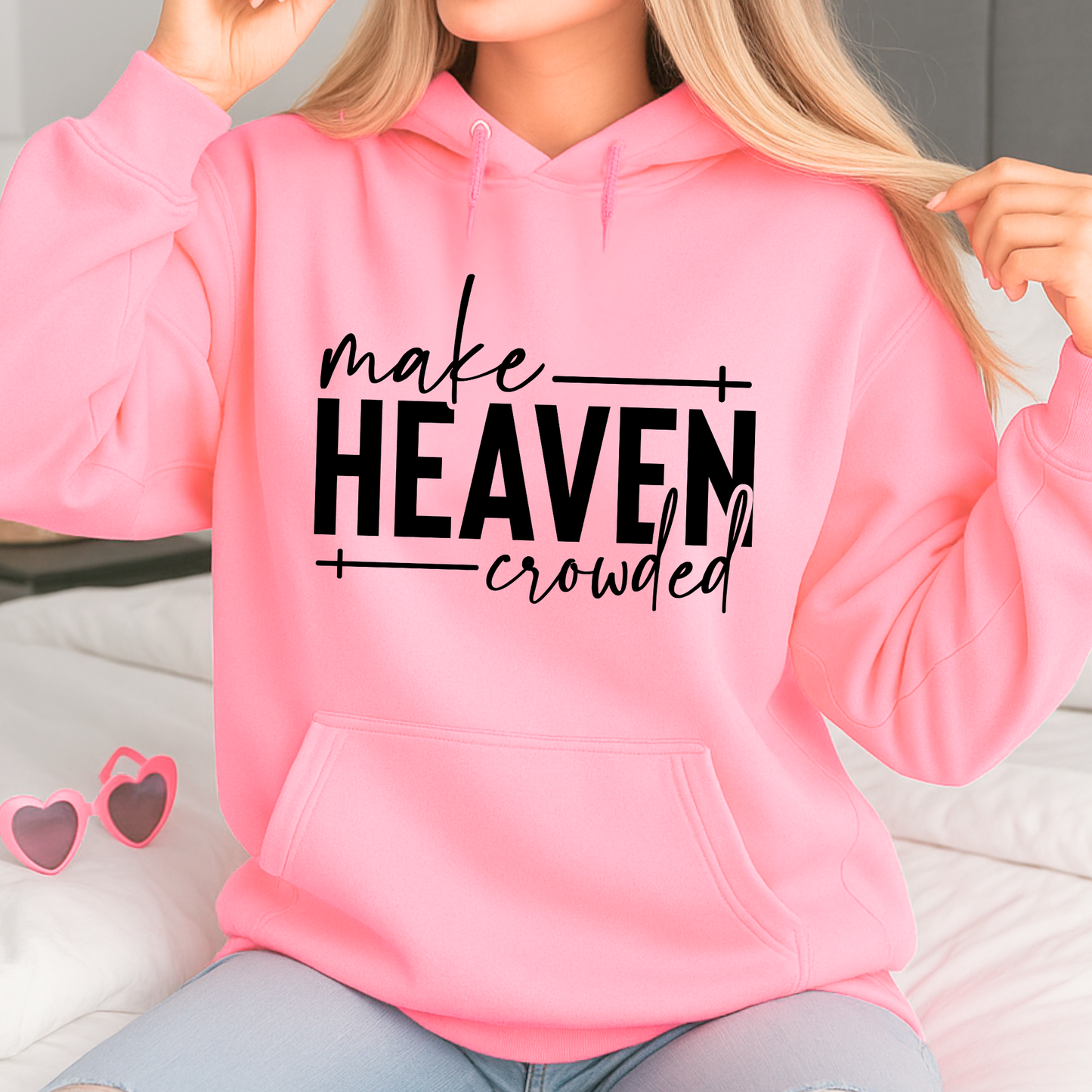 Make Heaven Crowded design on pink sweatshirt worn by woman