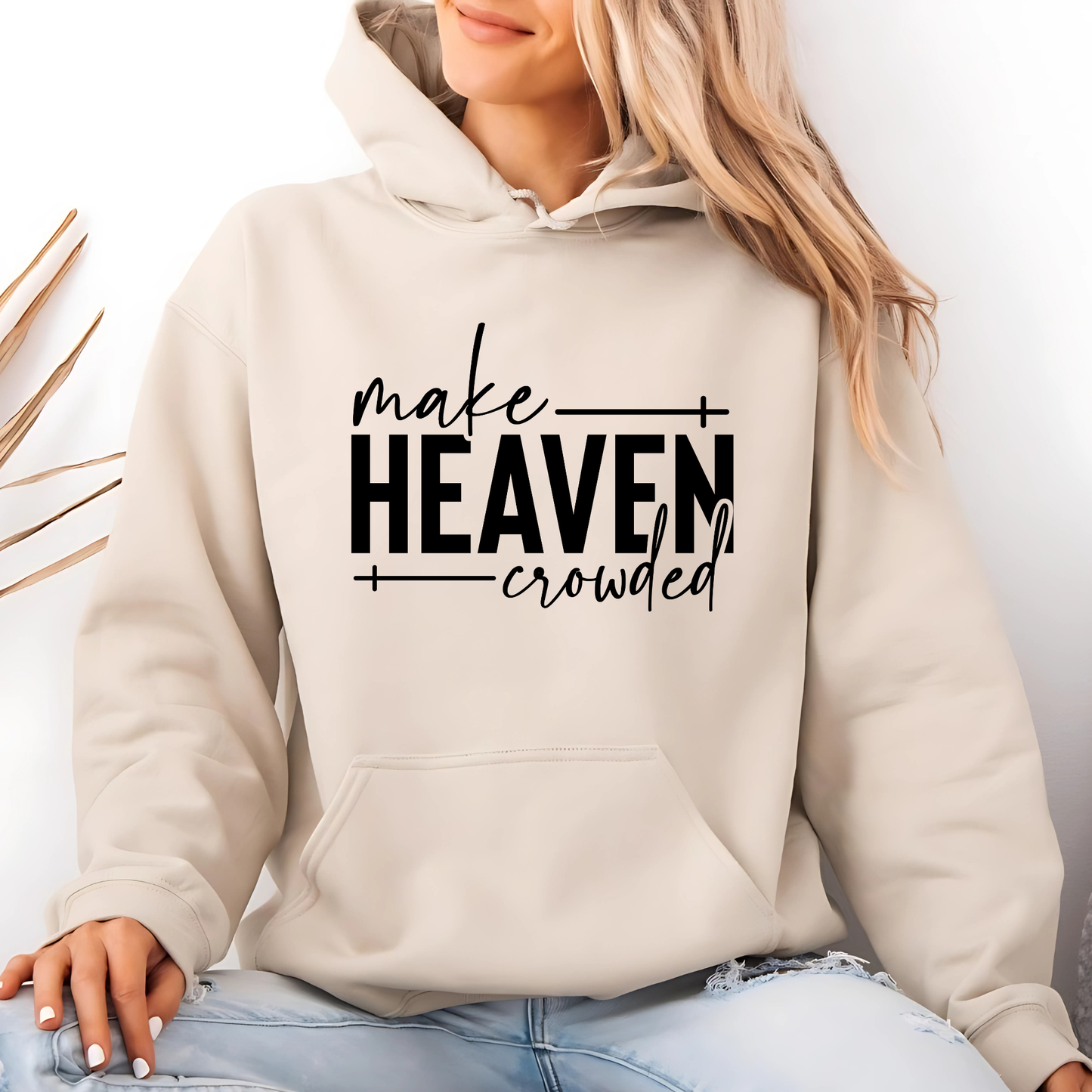 Make Heaven Crowded design on cream sweatshirt worn by woman