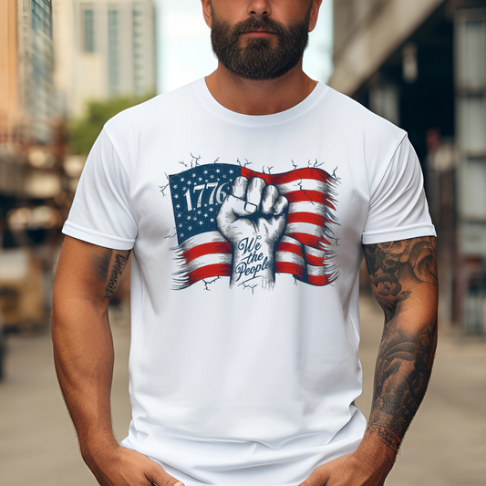 Man in sand 1776 shirt with American flag design and tattooed arm


