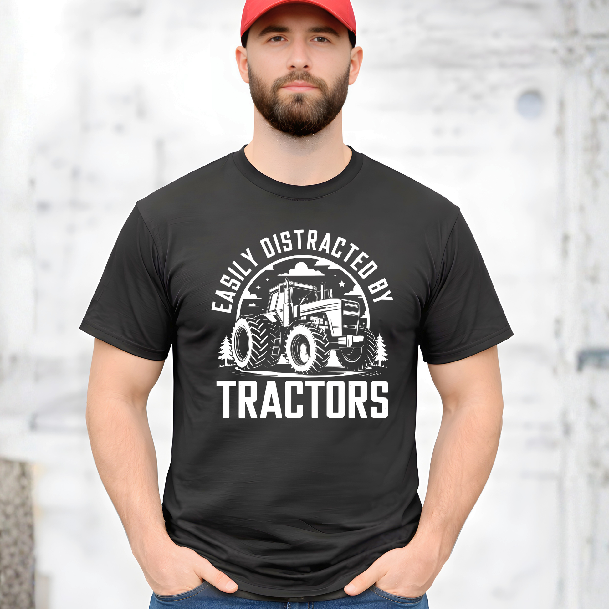 Man wearing a black t-shirt with a tractor graphic and text, standing against a light background