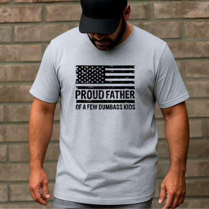 Man wearing a gray t-shirt with an American flag design and text against a brick wall.