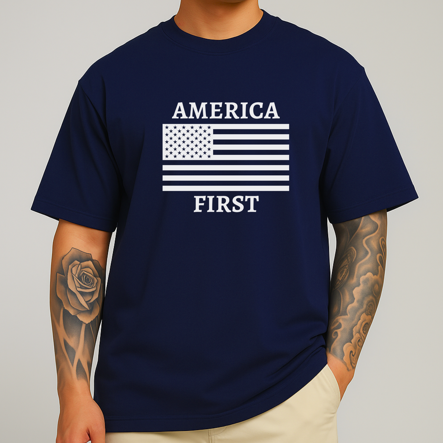 Man with arm tattoo wearing navy blue America First t-shirt with white flag print

