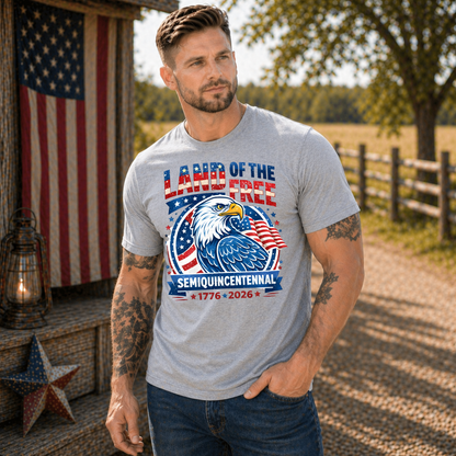 Man wearing a t-shirt with an eagle and American flag design outdoors.