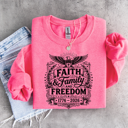 Pink sweatshirt with 'Faith & Family & Freedom' text on a concrete surface