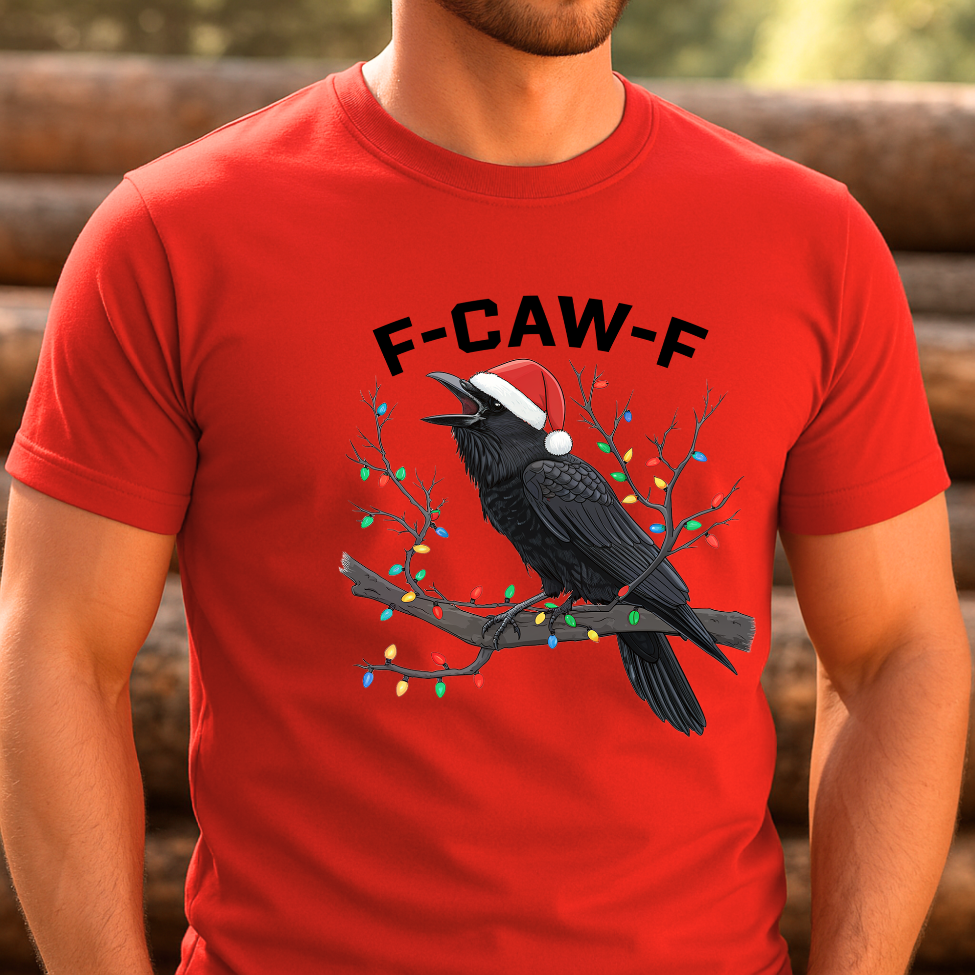 Red t-shirt with a black crow wearing a Santa hat and Christmas lights, text 'F-CAW-F', against a blurred natural background.