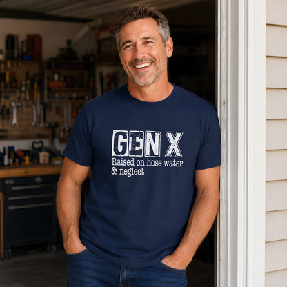 Man wearing a navy Gen X T-shirt with distressed “Raised on hose water & neglect” lettering in a garage setting.