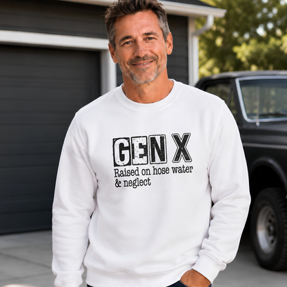 Man wearing a white Gen X crewneck sweatshirt with distressed “Raised on hose water & neglect” lettering beside a vintage truck.